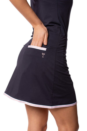 Women's navy skort with white and pink striped trim on back pocket and bottom
