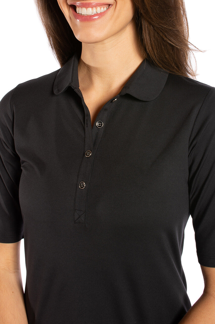 Closeup of women's black elbow length golf polo with button collar