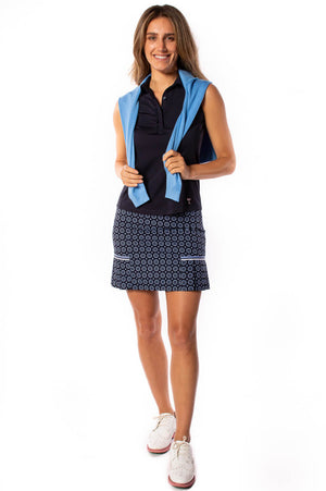 Navy women's golf outfit with sky blue sweater and matching printed skort