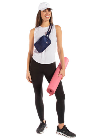 Woman getting ready for yoga wearing cute martini legging and athletic sports top wearing essential bag