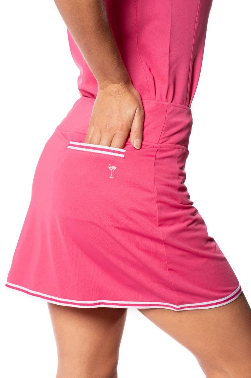 Hot pink sport skirt for golf tennis and pickleball with a white striped trim on bottom and back scorecard pocket