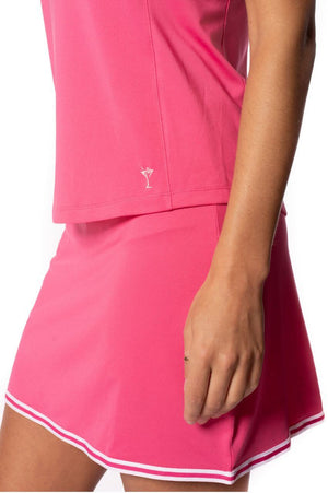 Women's matching pink golf and tennis set with matching skort and sleeveless top and a martini logo