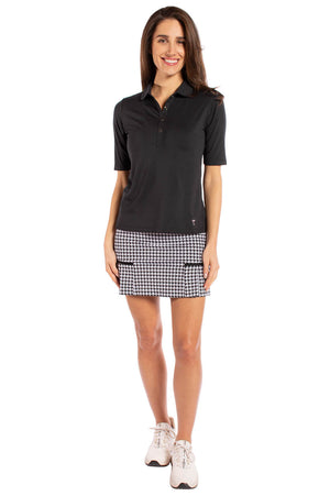 Cute women's black elbow length golf polo with black houndstooth skort