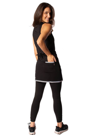 Women's black sporty outfit with black designer skort leggings and sleeveless workout top