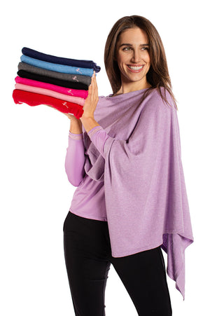 woman wearing lavender golf poncho holding beautiful color ponchos