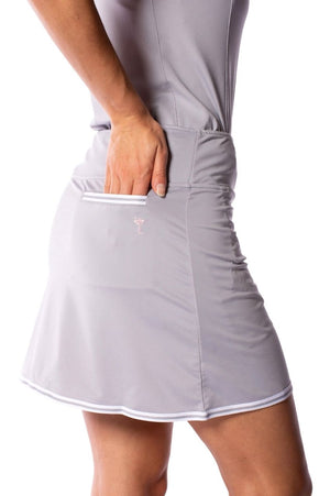 Silver golf skort with white striped trim on back scorecard pocket and along the bottom of the skirt
