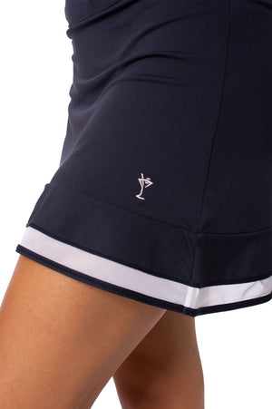 Navy and white golf and tennis skort with white mesh trim and light pink martini logo and hidden ball pocket for golf and tennis