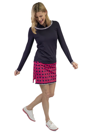 Women's hot pink and navy stretch designer golf skort with bottom trim. Women's navy long sleeve stretch top.
